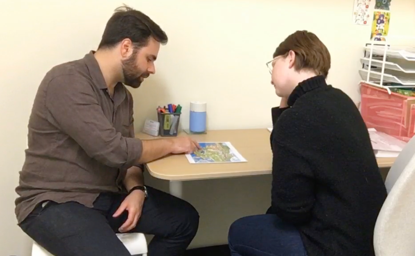 Psychologist reviewing assessment materials with client